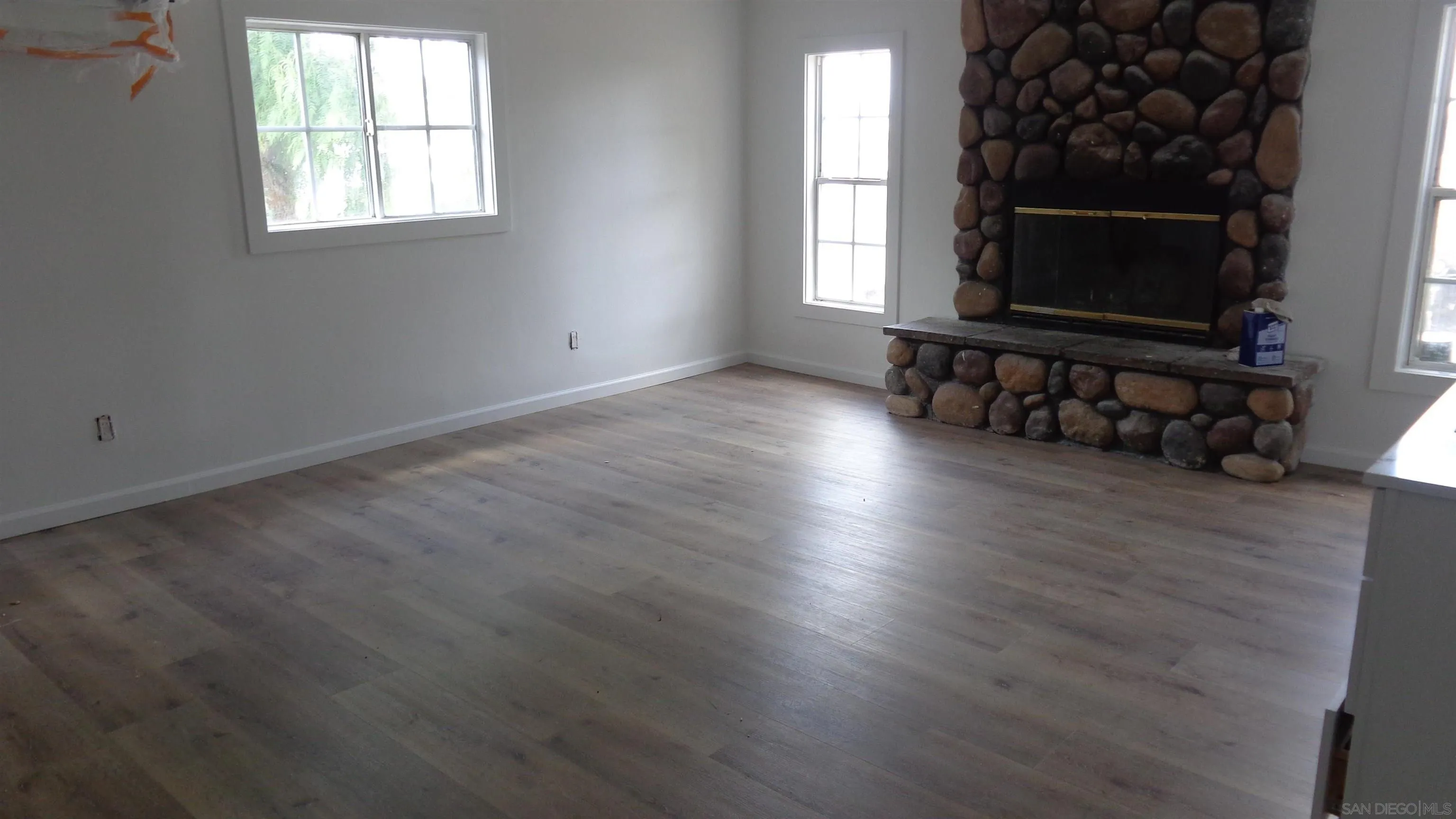 29660 Wilkes Road Valley Center, CA 92082 - Photo 9 of 16 an empty room with wooden floor and windows
