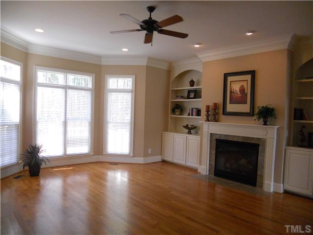 94 Winding Ridge Road Durham, NC 27713 - Photo 2 of 12 a view of a livingroom with a fireplace a ceiling fan and wooden floor