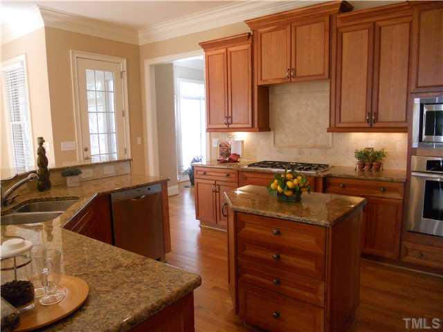 94 Winding Ridge Road Durham, NC 27713 - Photo 3 of 12 a kitchen with granite countertop a sink a stove and cabinets