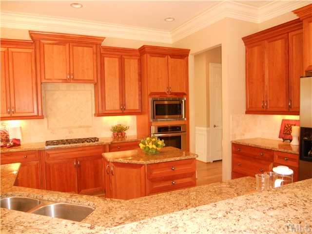 94 Winding Ridge Road Durham, NC 27713 - Photo 4 of 12 a kitchen with stainless steel appliances granite countertop a stove a sink and a microwave