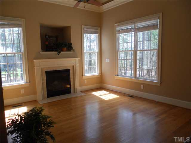 94 Winding Ridge Road Durham, NC 27713 - Photo 5 of 12 a view of empty room with fireplace and wooden floor