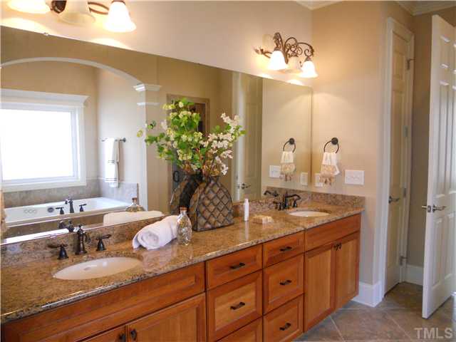 94 Winding Ridge Road Durham, NC 27713 - Photo 8 of 12 a bathroom with a granite countertop double vanity sink and a mirror