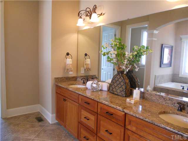94 Winding Ridge Road Durham, NC 27713 - Photo 9 of 12 a bathroom with a granite countertop double vanity sink and a mirror