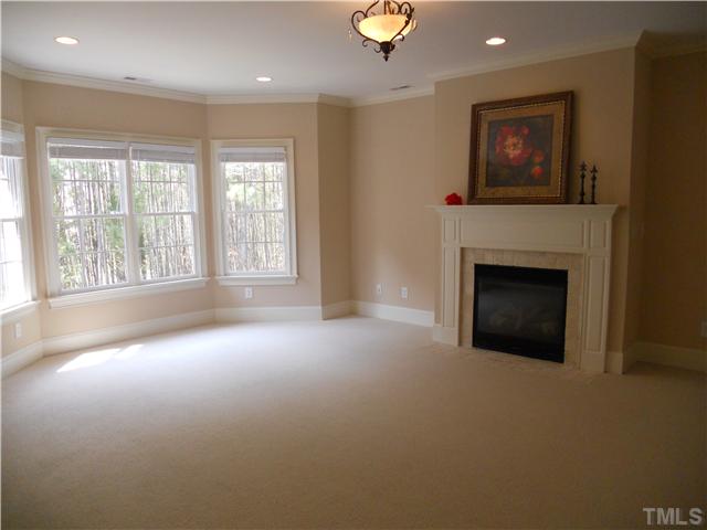 94 Winding Ridge Road Durham, NC 27713 - Photo 10 of 12 an empty room with windows and fireplace