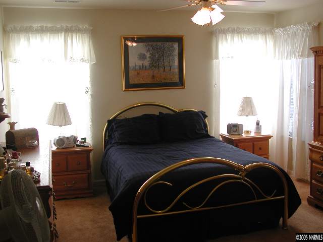 7577 Whimbleton Way Reno, NV 89511 - Photo 8 of 9 a bedroom with a bed and window