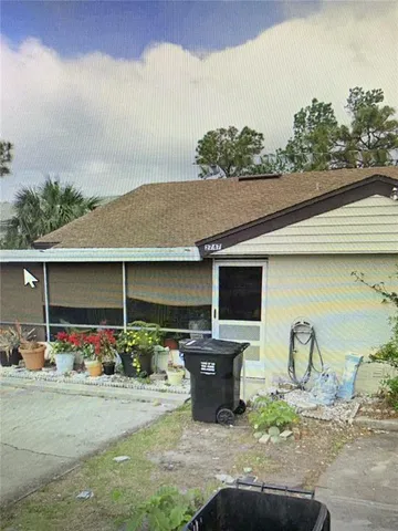 a backyard of a house with table and chairs