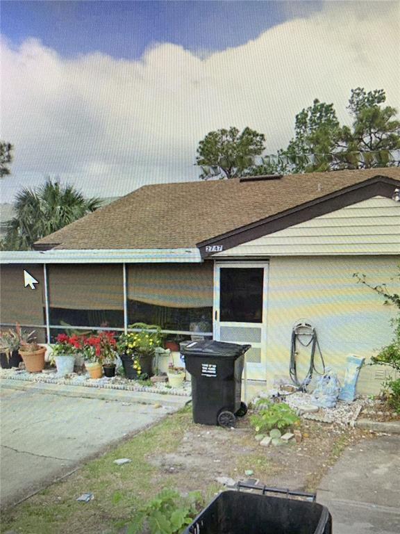 a backyard of a house with table and chairs