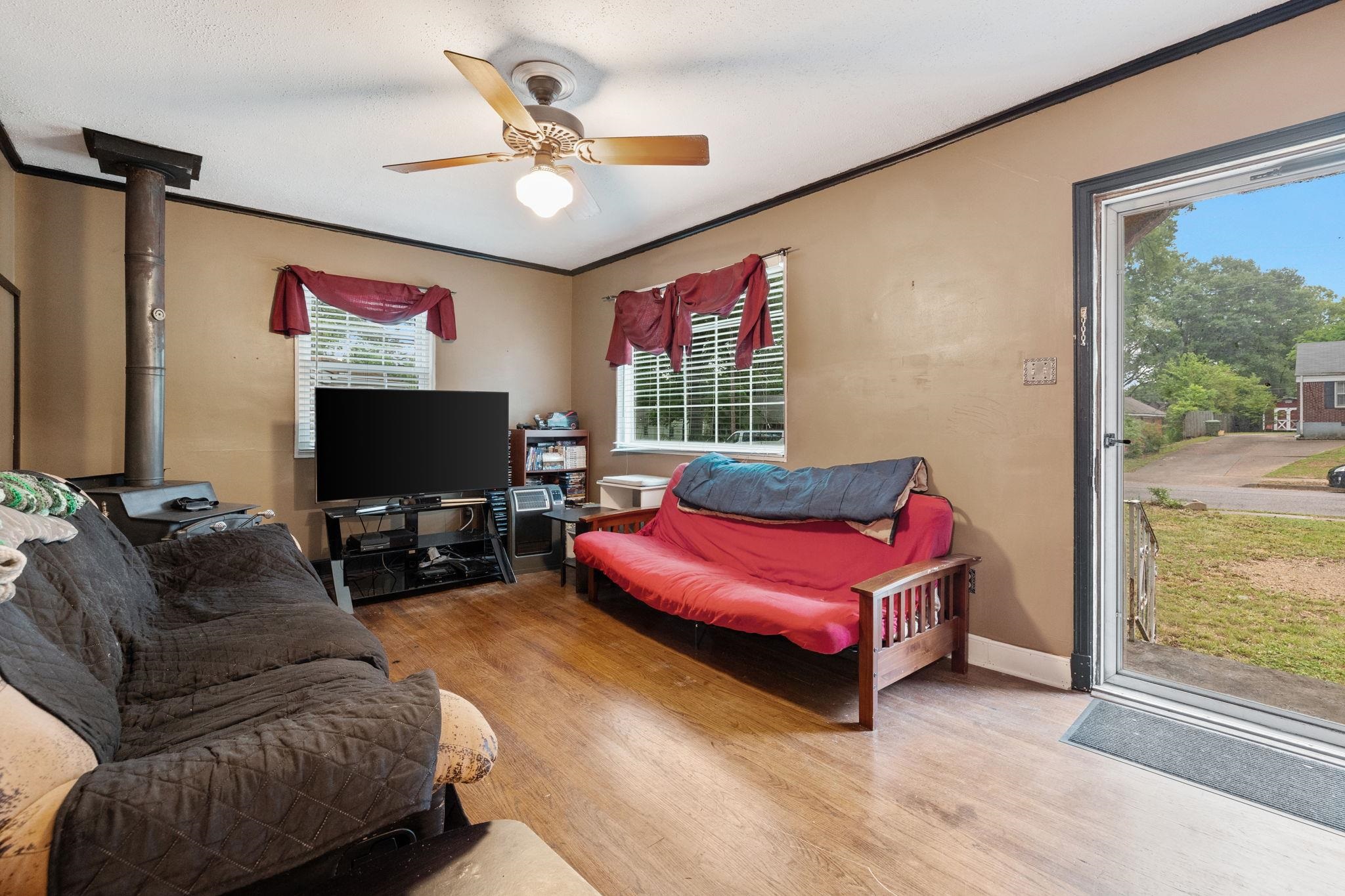 981 Tatum Road Memphis, TN 38122 - Photo 3 of 16 a living room with furniture a flat screen tv and a large window