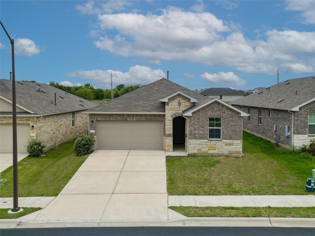 a front view of house with yard and green space