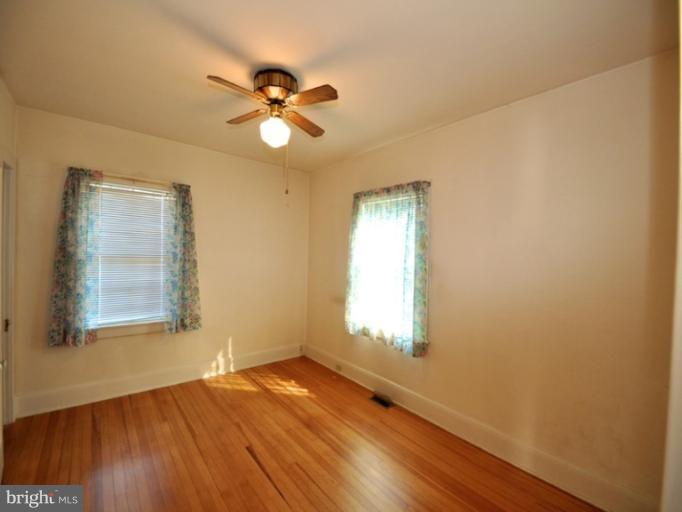 204 Wampler Road Middle River, MD 21220 - Photo 12 of 22 a view of an empty room with wooden floor and a window