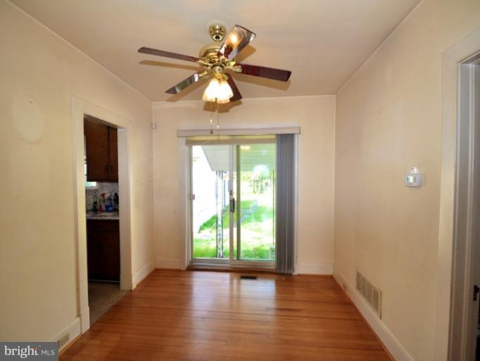 204 Wampler Road Middle River, MD 21220 - Photo 14 of 22 wooden floor in an empty room with a window