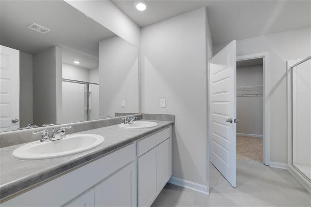 652 Whitman Lane Stockbridge, GA 30281 - Photo 23 of 36 a bathroom with a granite countertop sink and a mirror
