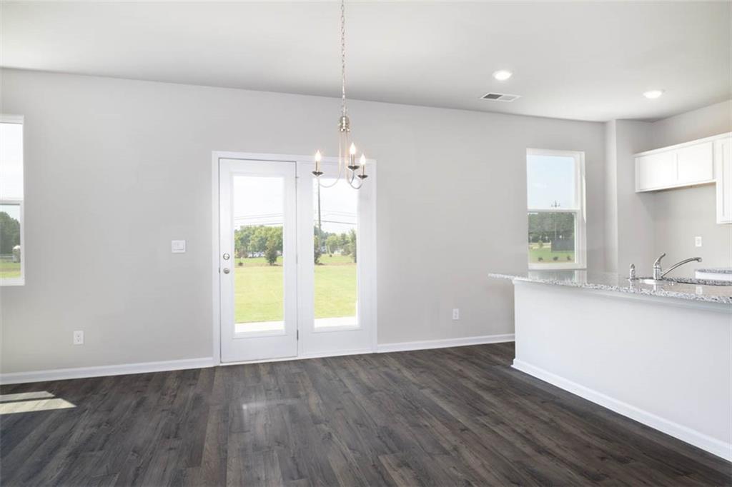 652 Whitman Lane Stockbridge, GA 30281 - Photo 30 of 36 an empty room with wooden floor and windows