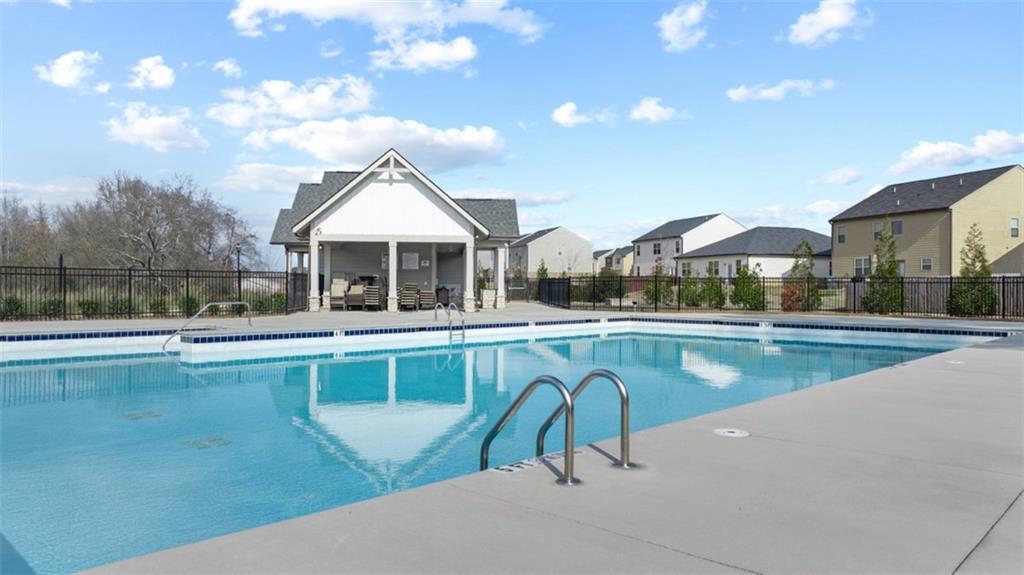 652 Whitman Lane Stockbridge, GA 30281 - Photo 3 of 36 a view of a swimming pool with a table and chairs under an umbrella