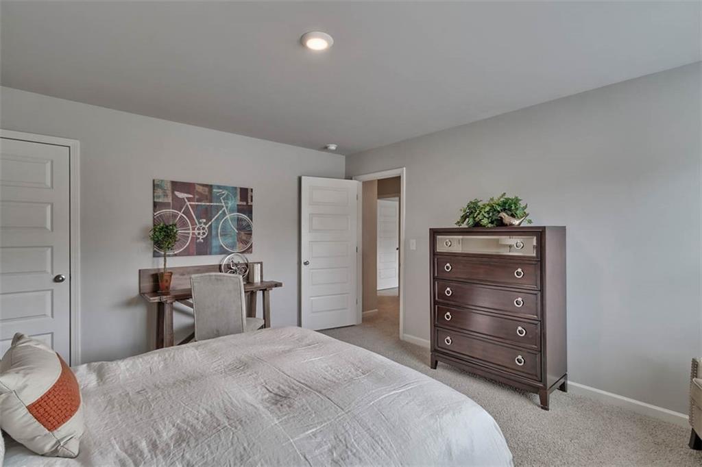 652 Whitman Lane Stockbridge, GA 30281 - Photo 32 of 36 a bedroom with a bed and a dresser