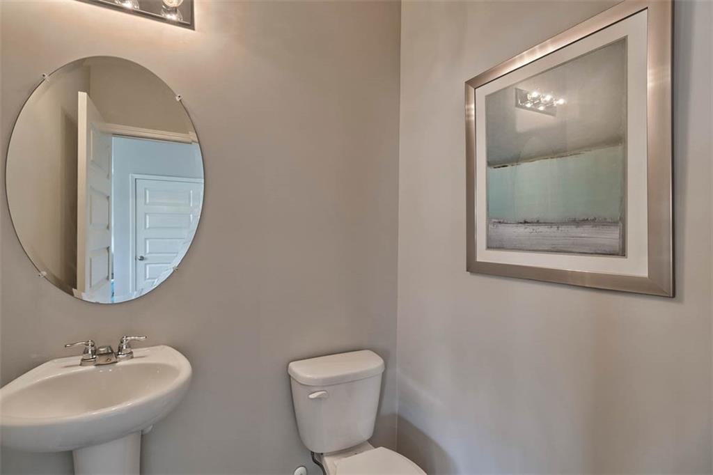 652 Whitman Lane Stockbridge, GA 30281 - Photo 35 of 36 a bathroom with a toilet sink and mirror
