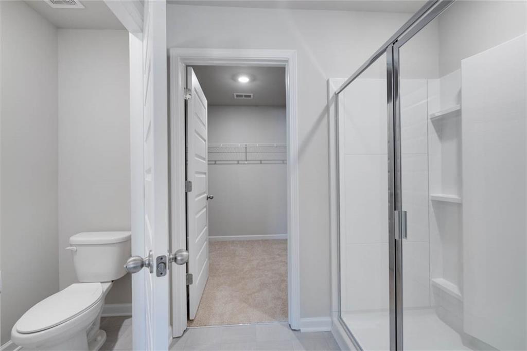 652 Whitman Lane Stockbridge, GA 30281 - Photo 8 of 36 a bathroom with a shower and a toilet