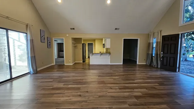 a kitchen with stainless steel appliances granite countertop a refrigerator a stove and a sink