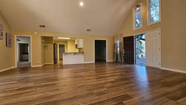 a kitchen with stainless steel appliances granite countertop a refrigerator and a stove top oven