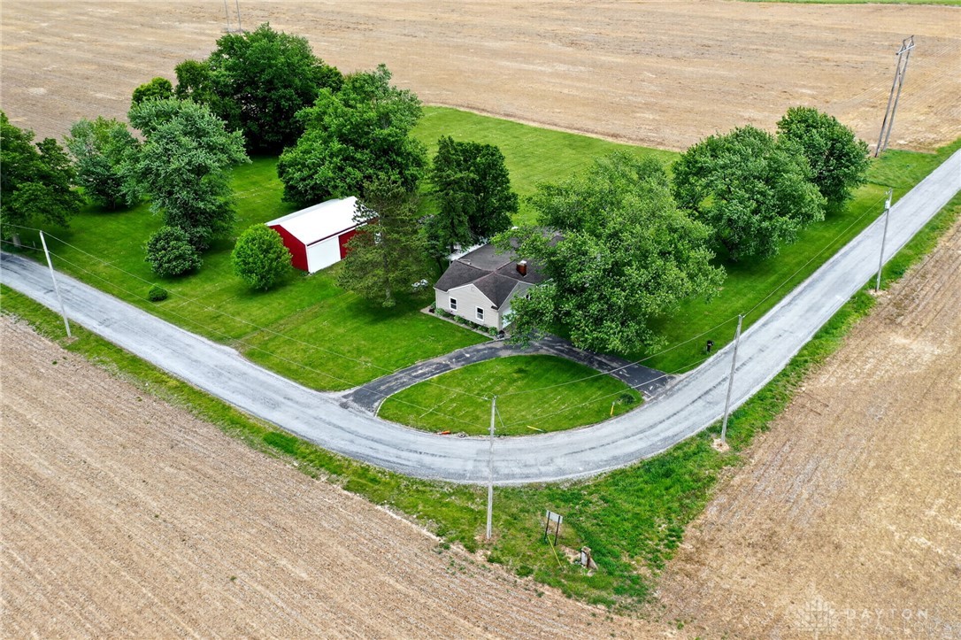 2470 Clark Run Road Xenia, OH 45385 - Photo 32 of 57 This aerial perspective showcases a quaint home nestled in a lush, green landscape, surrounded by open fields.
