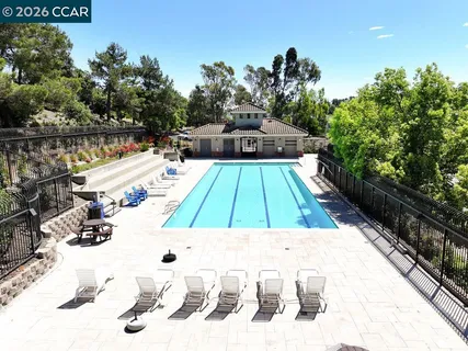 a view of a swimming pool with a patio and couches