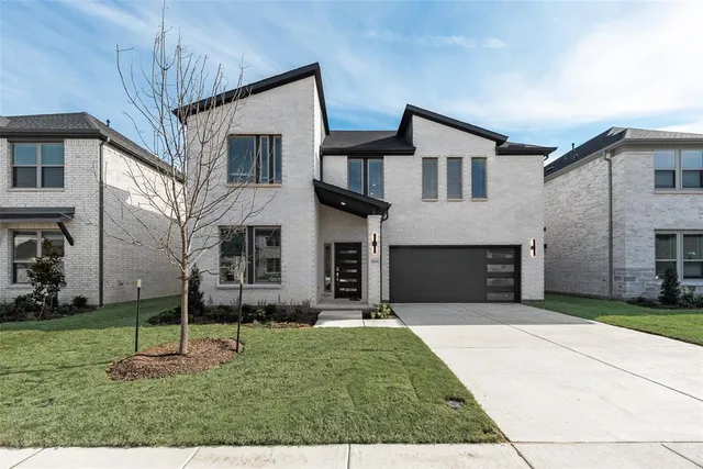 a view of a yard in front of a brick house