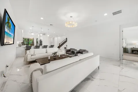 a living room with furniture a couch and a flat screen tv