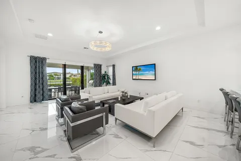 a living room with furniture and a potted plant
