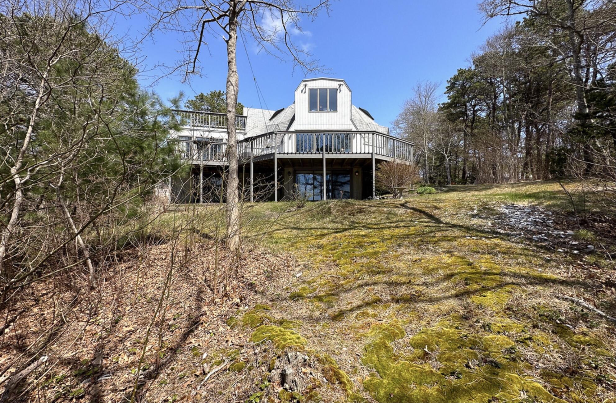 37 Amy Brown Road Mashpee, MA 02649 - Photo 7 of 59 a front view of a house with large trees