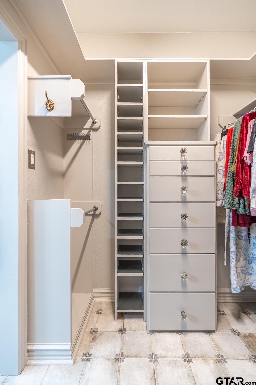 16142 Treasure Cove Bullard, TX 75757 - Photo 25 of 48 a view of walk in closet with empty racks