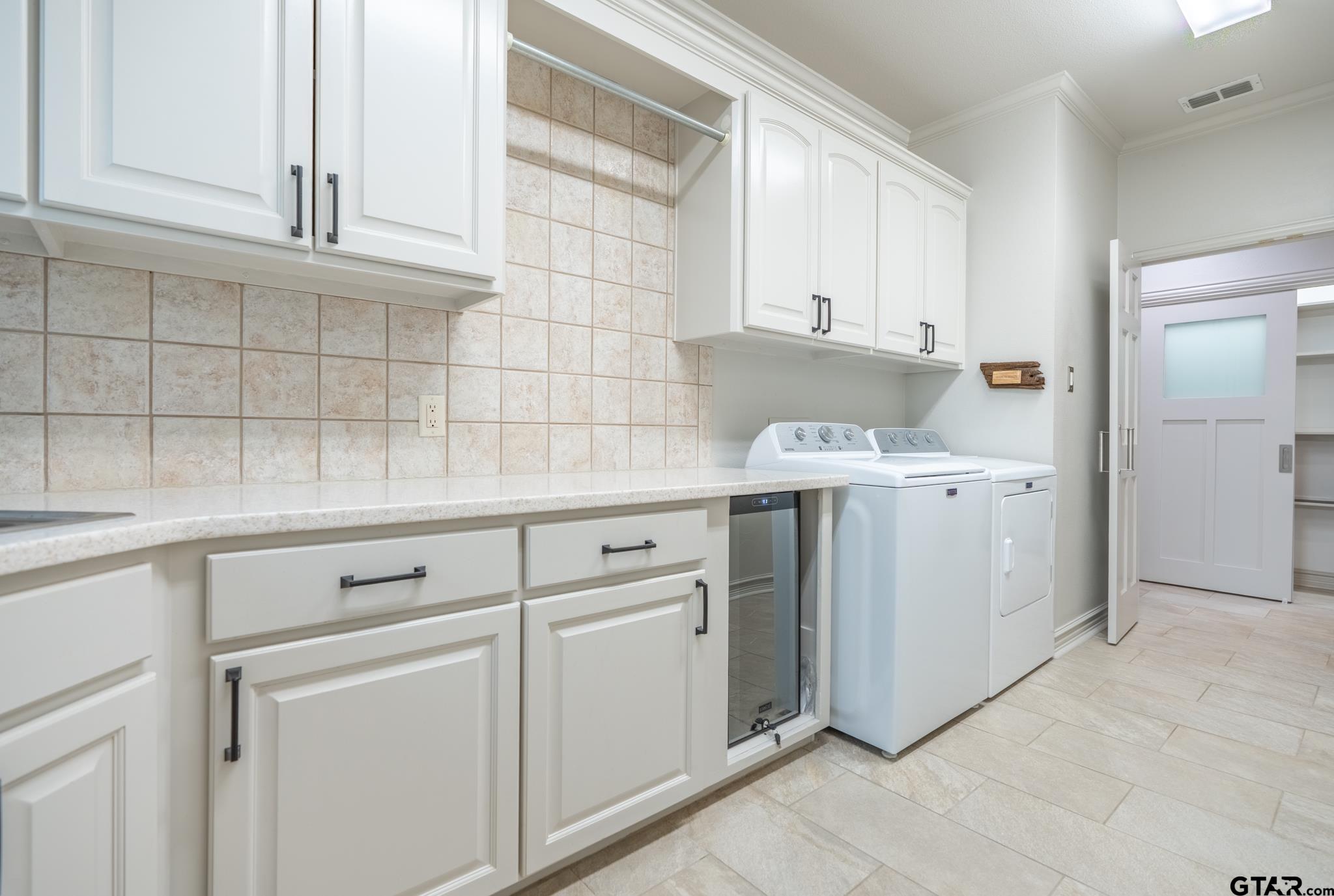 16142 Treasure Cove Bullard, TX 75757 - Photo 27 of 48 a kitchen with white cabinets appliances a sink and a window