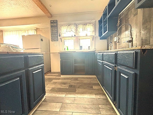 805 Rudyard Road Cleveland, OH 44110 - Photo 6 of 45 Kitchen with hardwood / wood-style flooring, beam ceiling, freestanding refrigerator, and open shelves