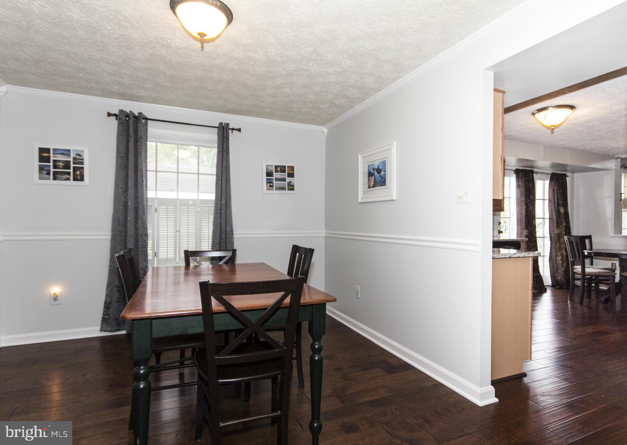 9336 Ramblebrook Road Baltimore, MD 21236 - Photo 14 of 30 a view of a dining room with furniture and wooden floor