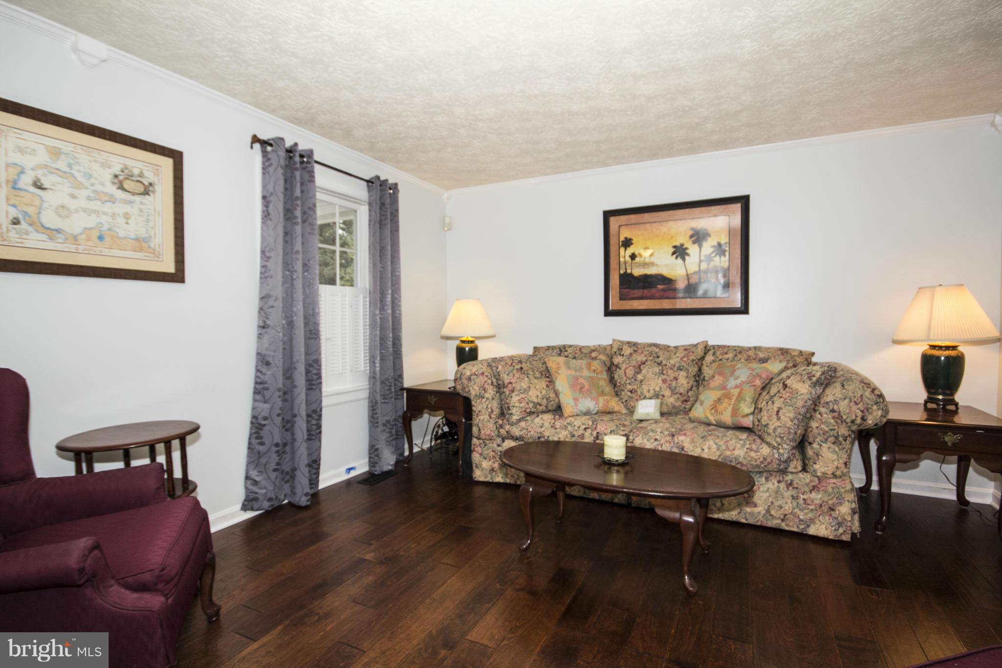 9336 Ramblebrook Road Baltimore, MD 21236 - Photo 10 of 30 a living room with furniture and a wooden floor