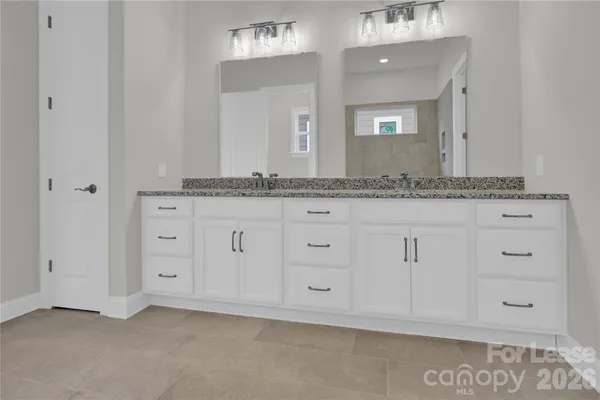 a bathroom with white cabinets