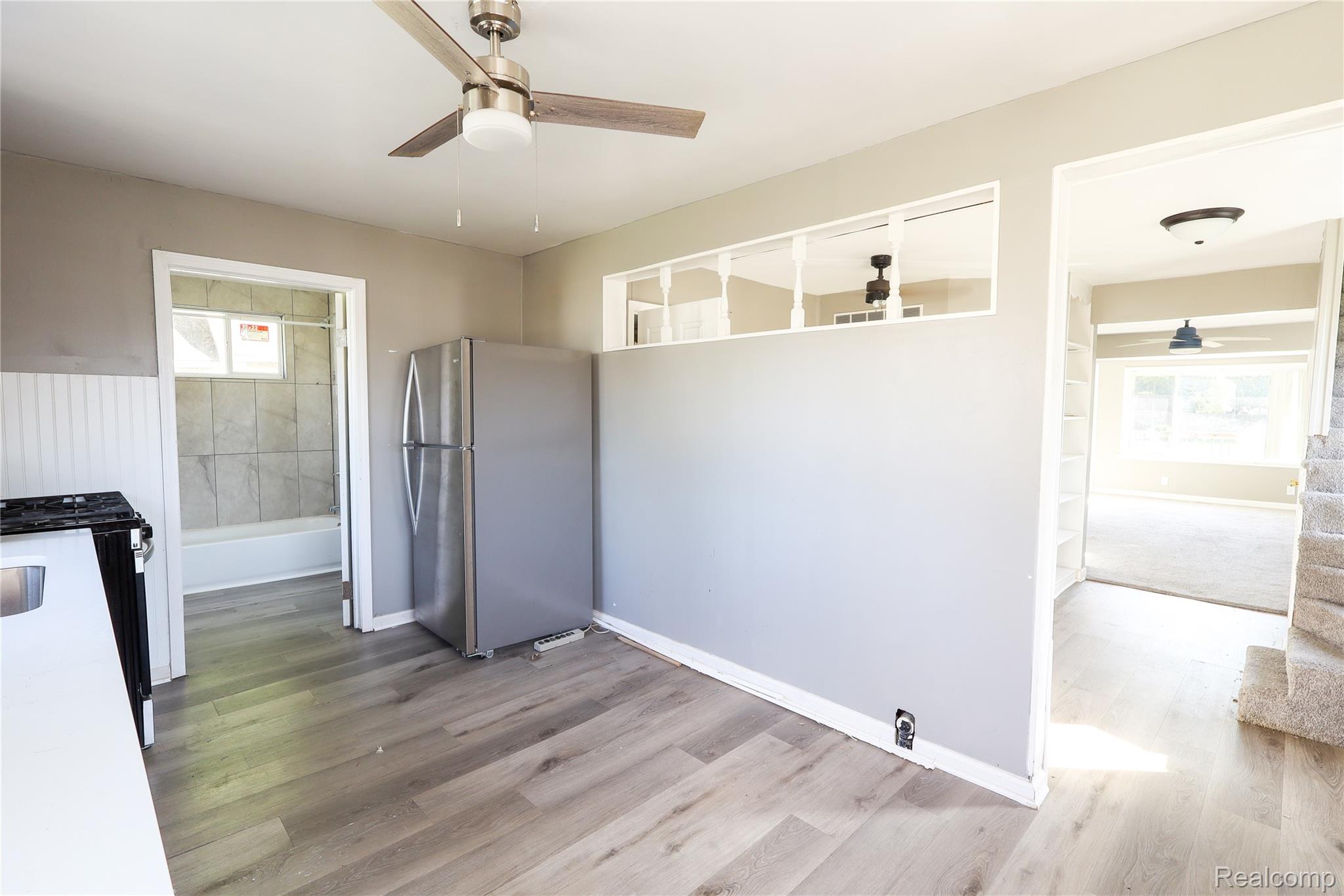 3319 Lakeview Street Monroe, MI 48162 - Photo 11 of 21 Kitchen area featuring wood-finish flooring, a stainless steel refrigerator, and a ceiling fan