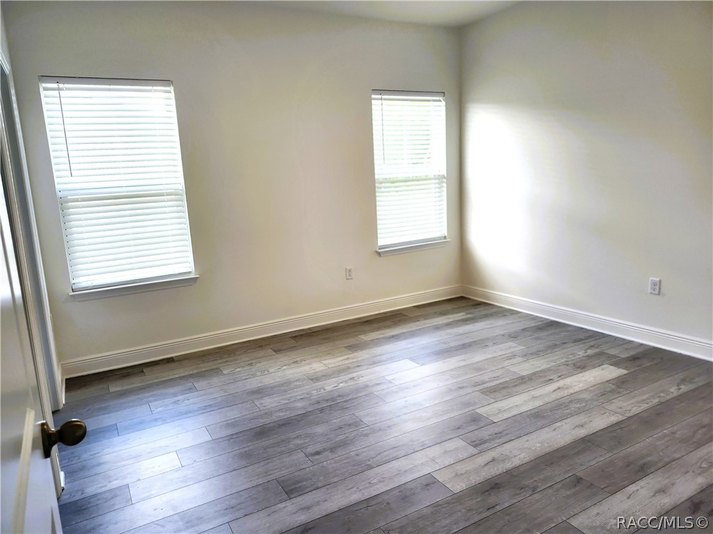2800 Southwest 139th Street Ocala, FL 34473 - Photo 9 of 16 an empty room with wooden floor and windows