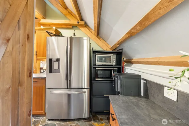 a kitchen with stainless steel appliances a refrigerator and a stove top oven