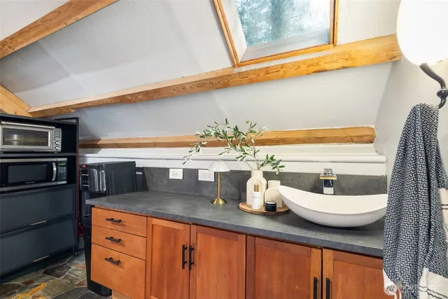 a kitchen with a sink a stove and cabinets