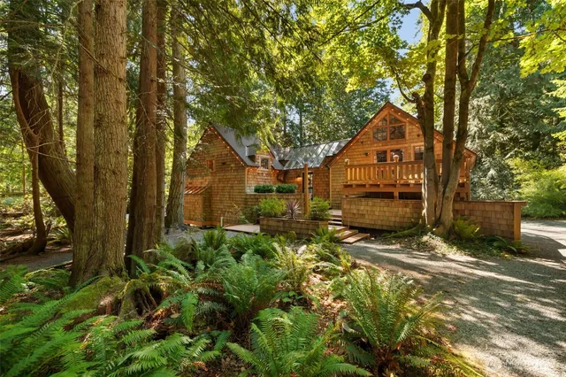 a view of backyard of house with green space