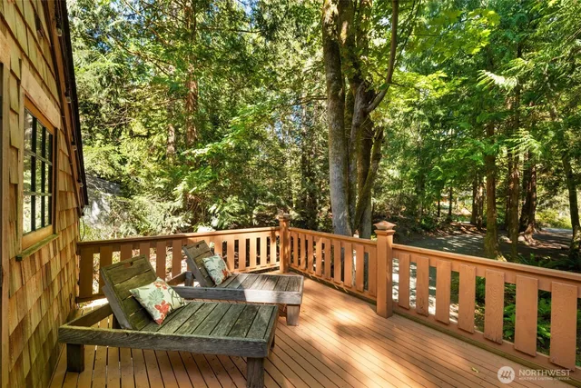 a view of house with wooden deck and city view