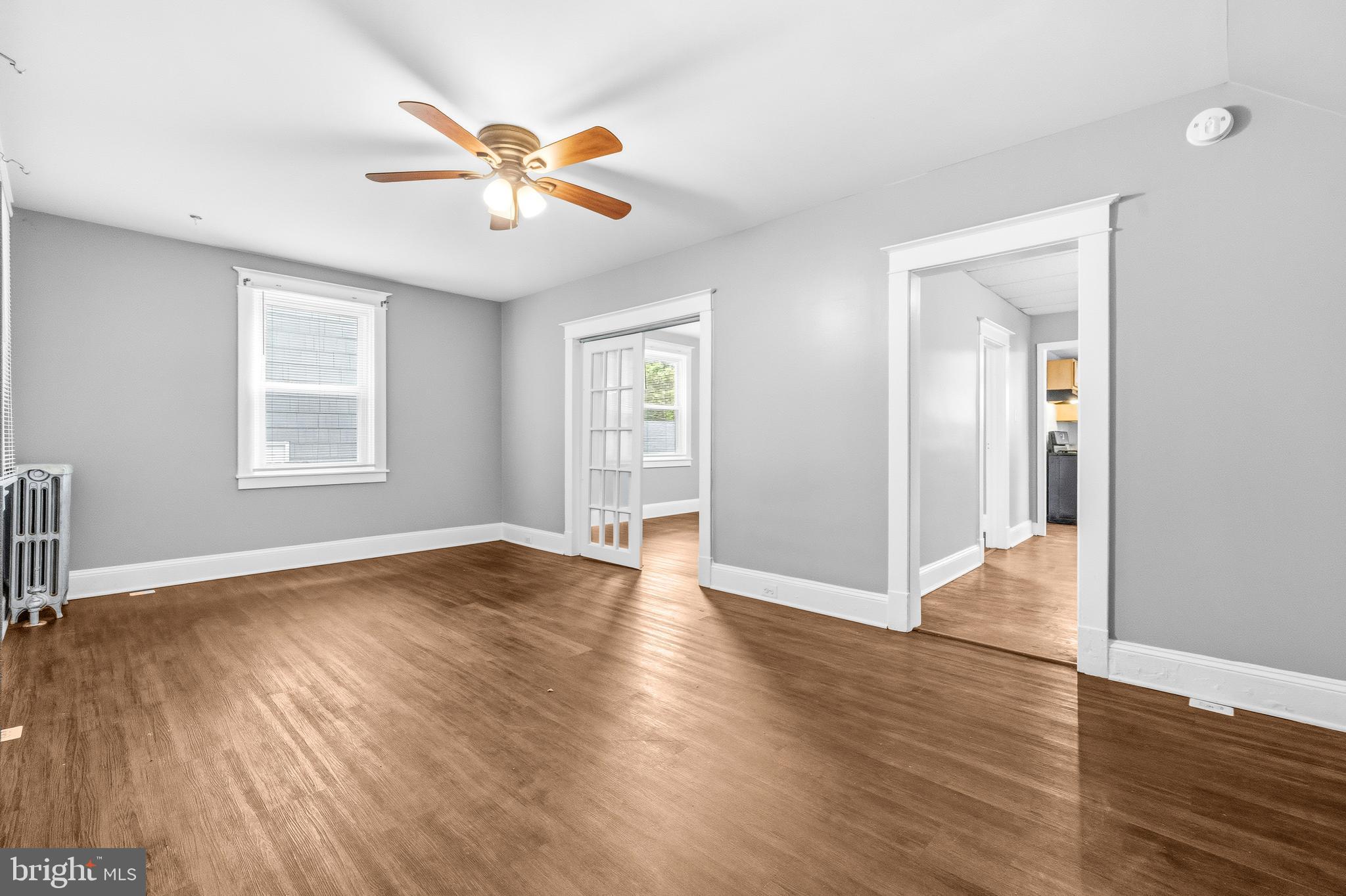12 Leeway Dundalk, MD 21222 - Photo 5 of 34 an empty room with wooden floor chandelier and windows
