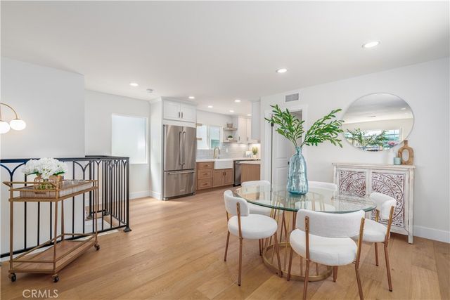 a dining room with furniture and a floor to ceiling window
