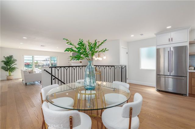 a dining room with furniture a rug and wooden floor