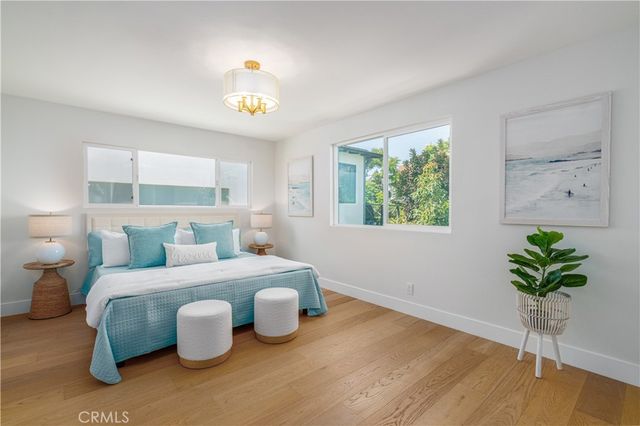 a bedroom with a bed and a potted plant