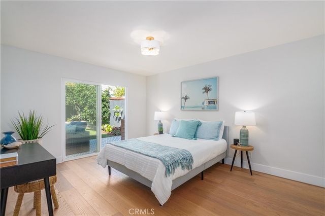 a bedroom with a large bed and a potted plant
