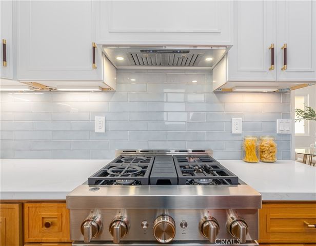 a kitchen with a stove and cabinets