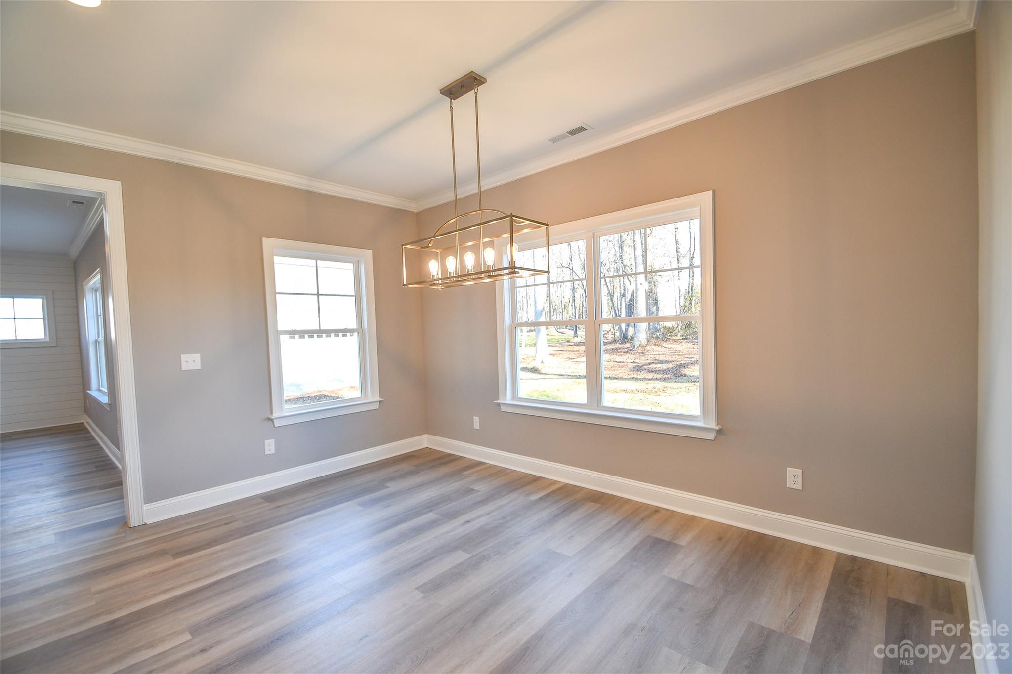 1620 McIntyre Road, Unit 8 Wingate, NC 28174 - Photo 15 of 31 a view of an empty room with wooden floor and a window