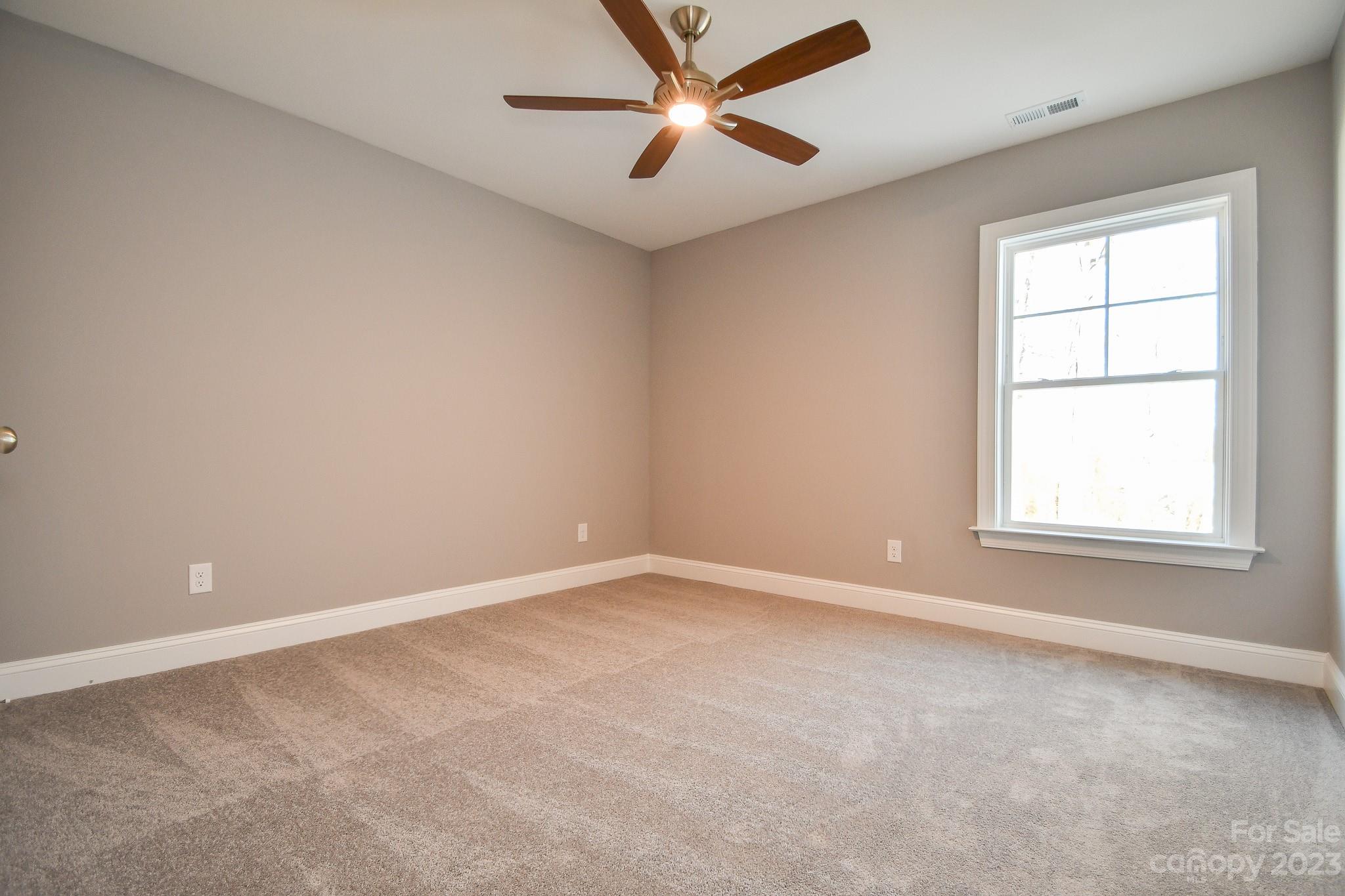 1620 McIntyre Road, Unit 8 Wingate, NC 28174 - Photo 16 of 31 an empty room with a window and a fan