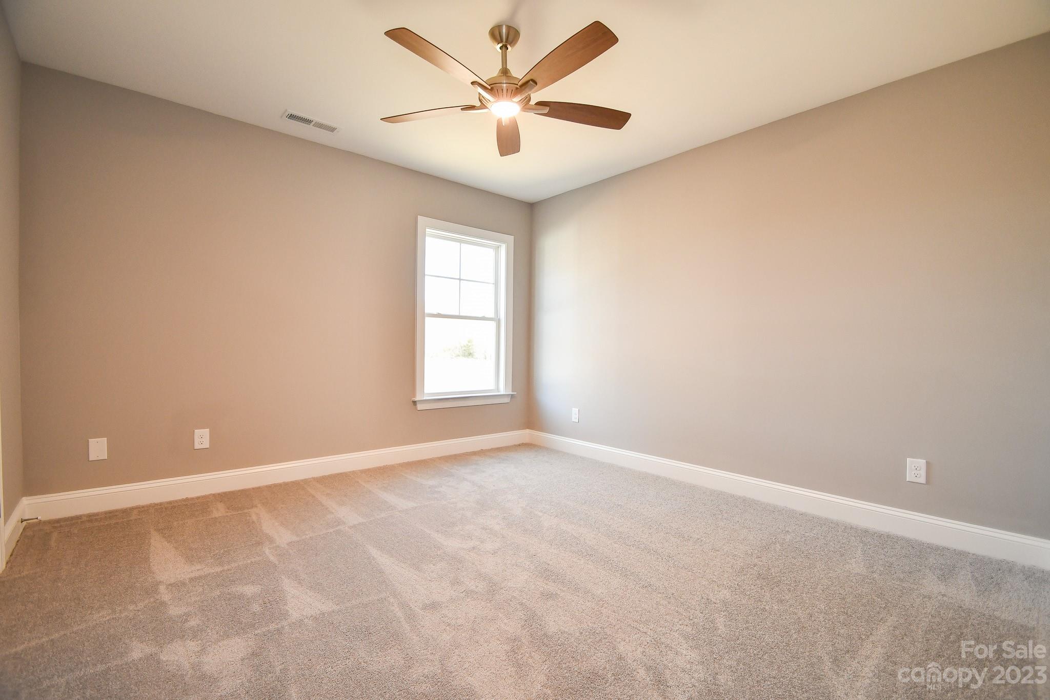 1620 McIntyre Road, Unit 8 Wingate, NC 28174 - Photo 17 of 31 an empty room with windows and fan